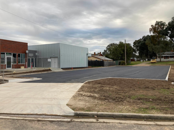 Freshly ashphalted carpark next to new community building