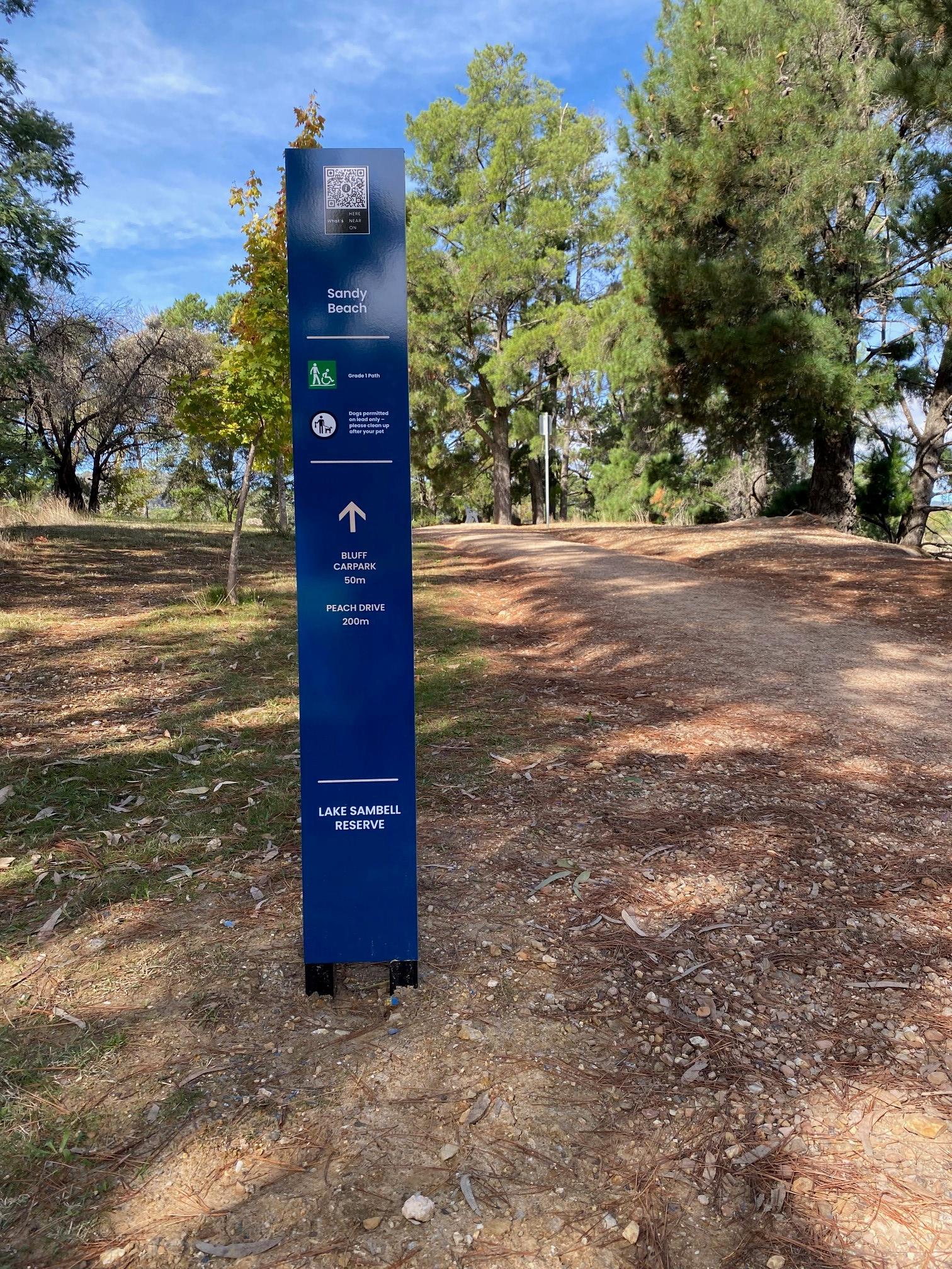 New blue sign installed near walking track at Lake Sambell