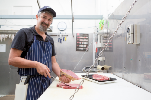 Butcher working with meat