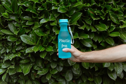 Hand holding a blue water bottle