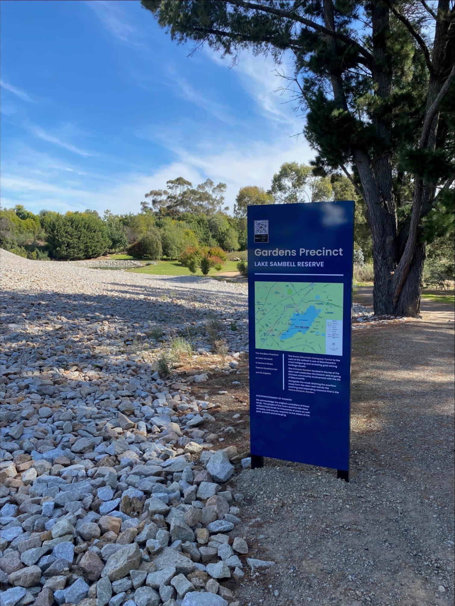 New blue sign with map installed near rocks at Lake Sambell